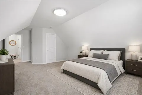 a bedroom with a bed and a lamp