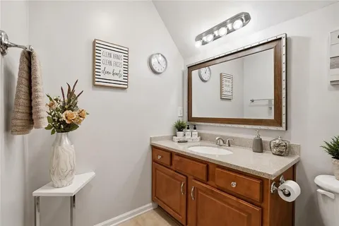 a bathroom with a sink vanity and a mirror