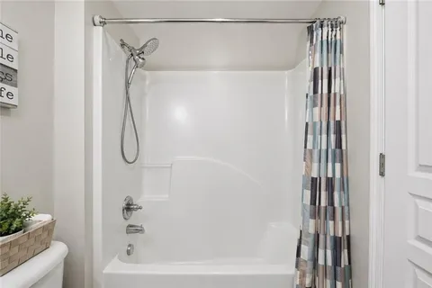 a bathroom with a shower and a shower curtain