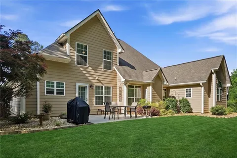 a front view of house with yard and green space