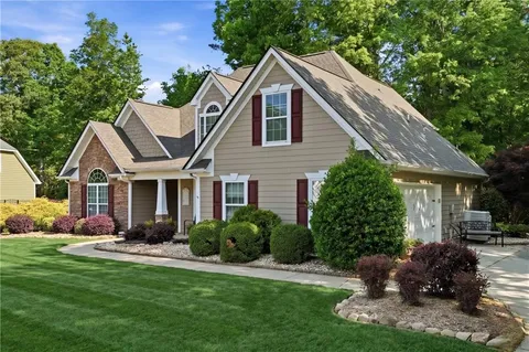 a front view of house with a garden