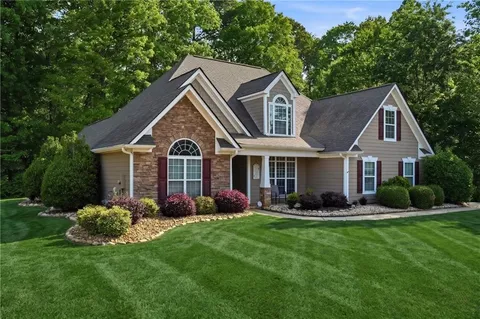a front view of house with yard and green space