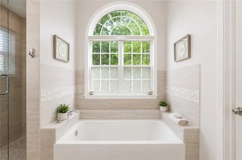 a white bath tub with a window