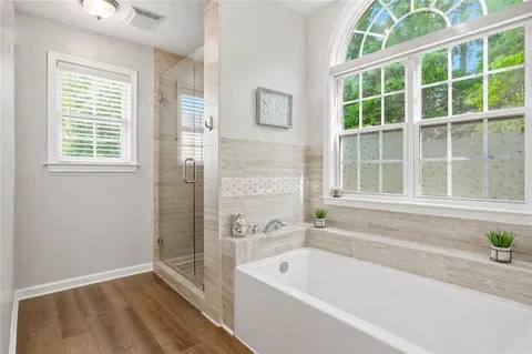 a bathroom with a bathtub and a shower