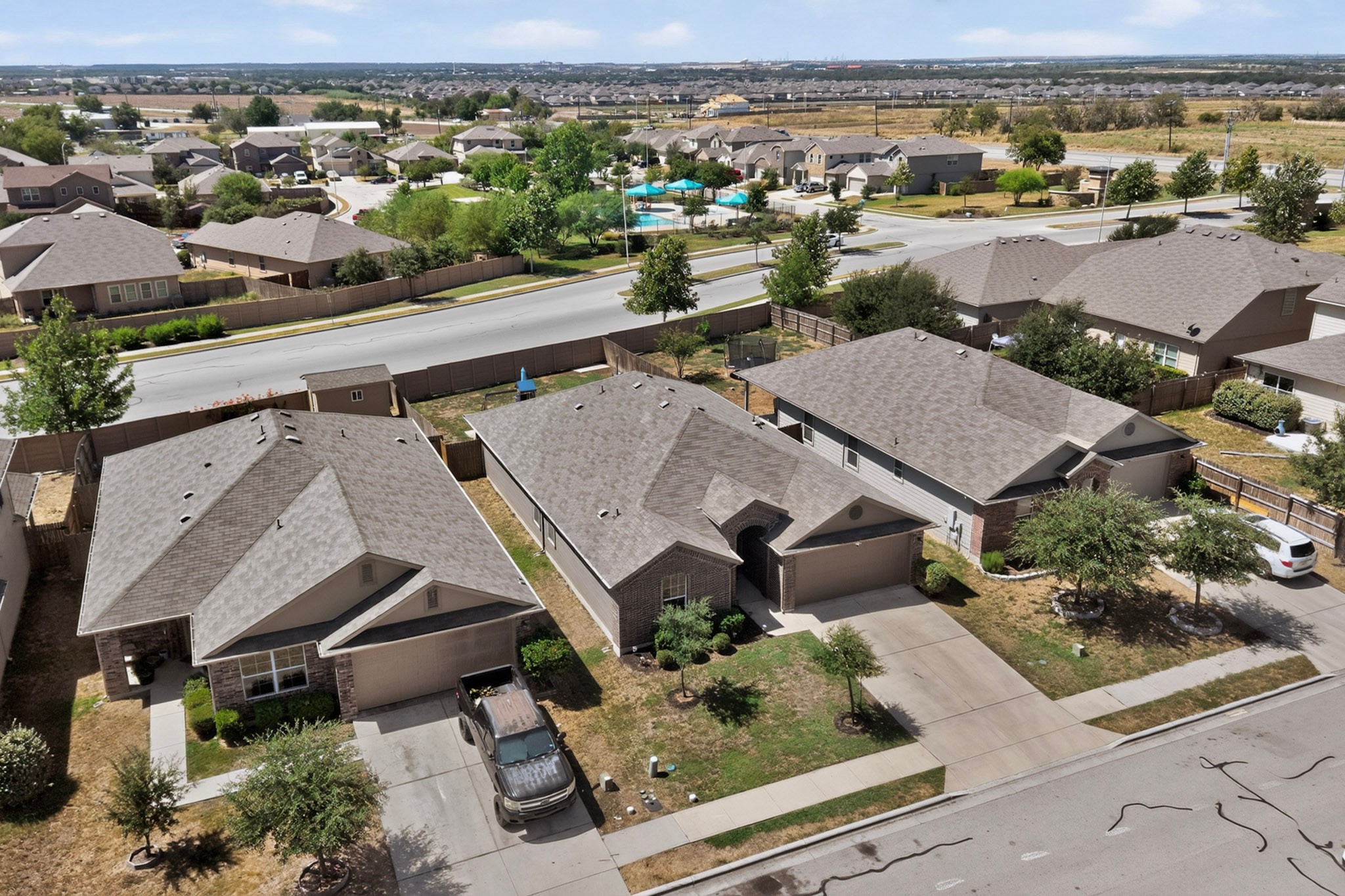 11612 Andesite Road Manor, TX 78653 - Photo 37 of 40 An aerial perspective captures shingle roofs and concrete driveways throughout this suburban neighborhood.