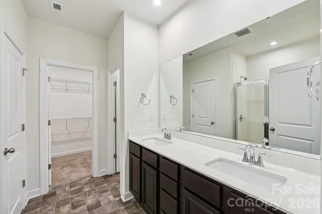 a bathroom with a sink double vanity and a mirror
