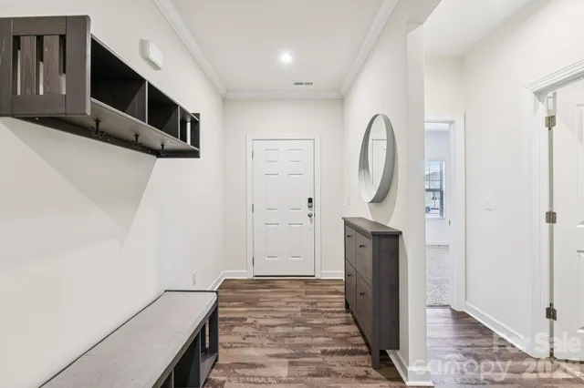 a view of a livingroom with wooden floor and a ceiling fan