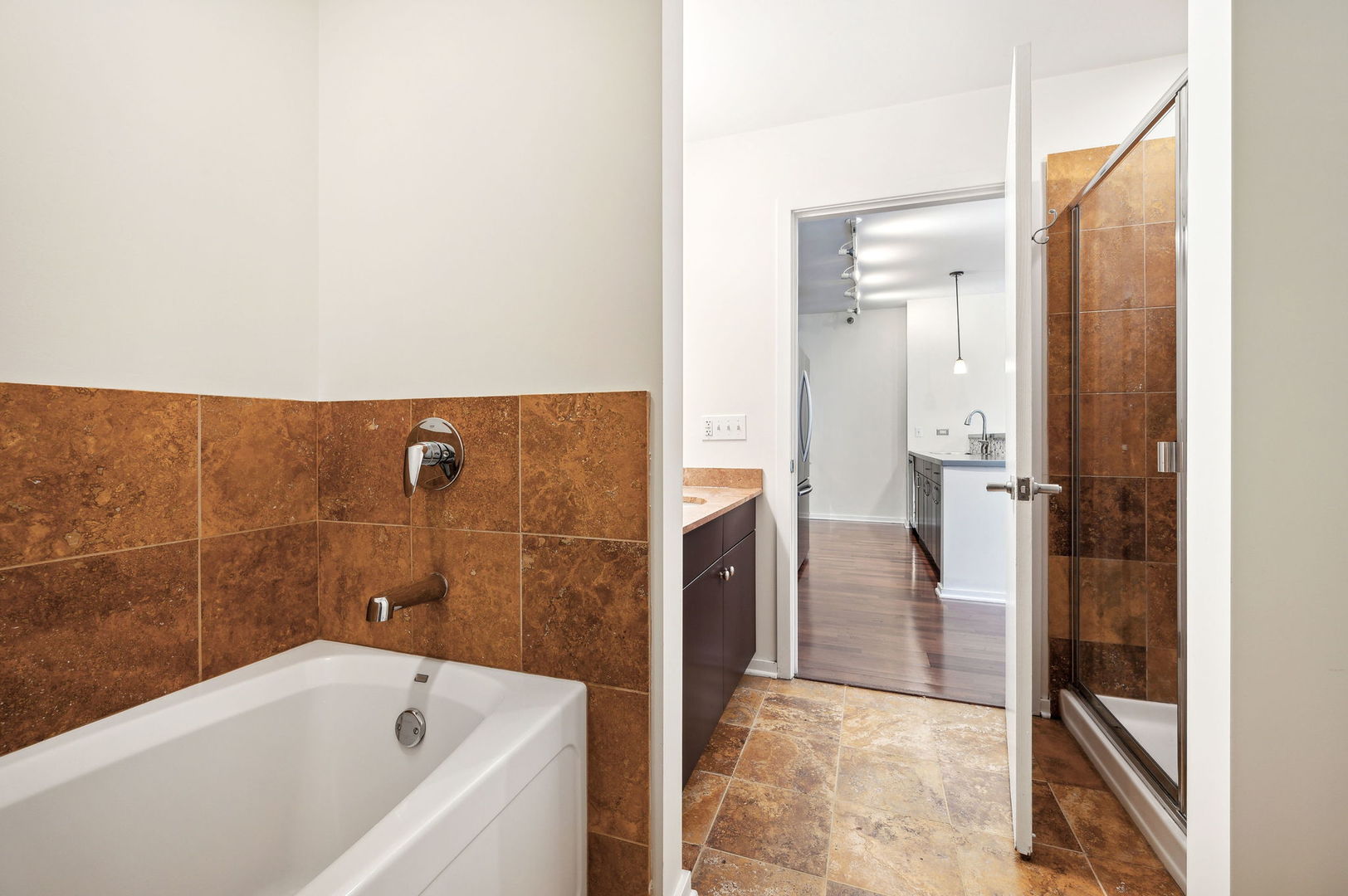123 South Green Street, Unit 407B Chicago, IL 60607 - Photo 15 of 20 a bathroom with a bathtub and a shower