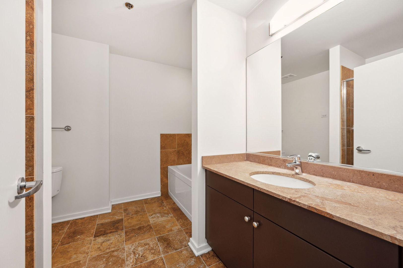 123 South Green Street, Unit 407B Chicago, IL 60607 - Photo 16 of 20 a bathroom with a granite countertop sink and a mirror
