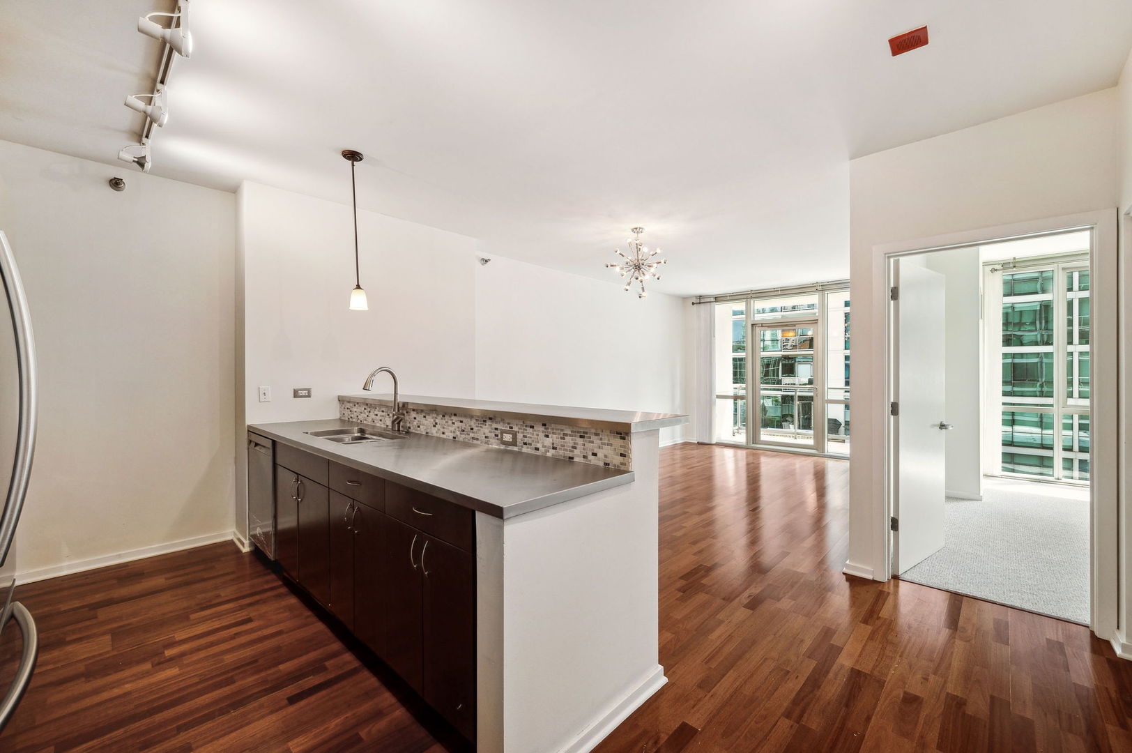 123 South Green Street, Unit 407B Chicago, IL 60607 - Photo 8 of 20 a kitchen with stainless steel appliances granite countertop a stove and wooden floor