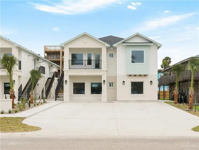 a view of a white house with large windows