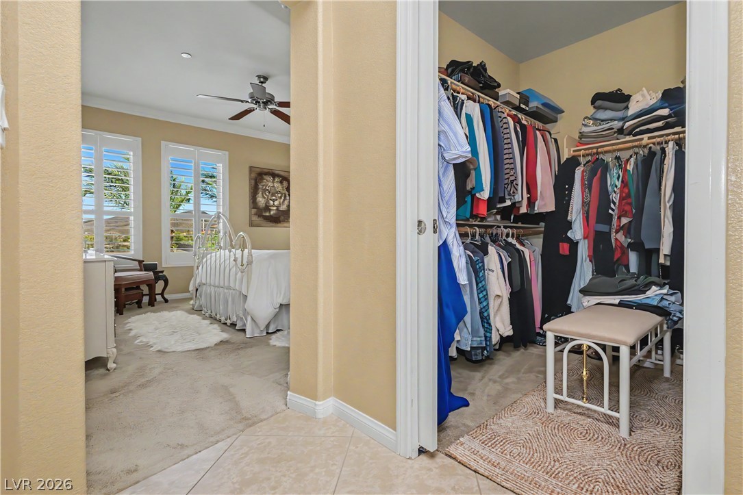 2555 Hampton Road, Unit 3308 Henderson, NV 89052 - Photo 40 of 65 Step into a bedroom offering a ceiling fan, plantation shutters, and a well-appointed walk-in closet for ample storage.