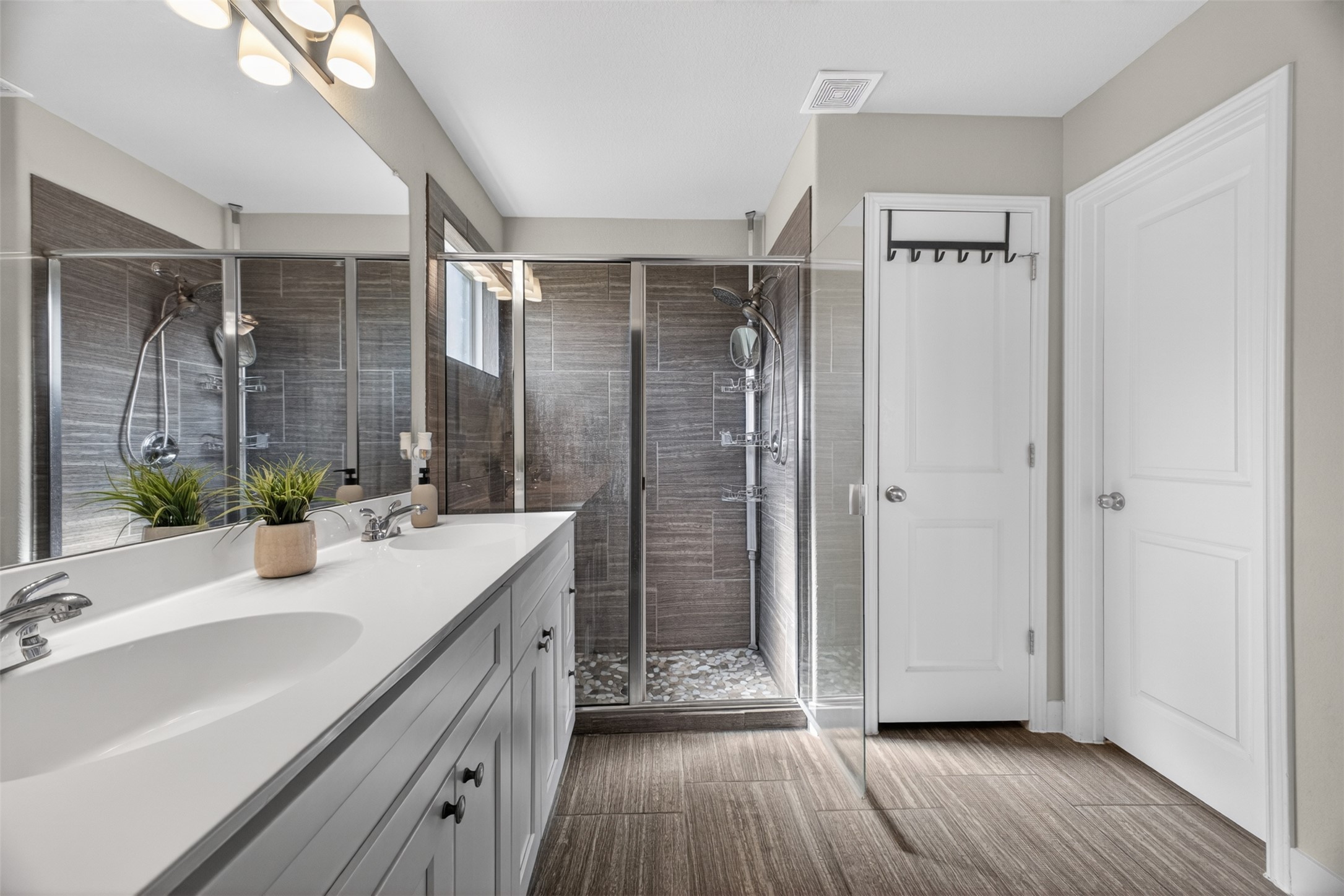 1009 Bright Star Cove Georgetown, TX 78628 - Photo 12 of 40 a bathroom with a double vanity sink and mirror