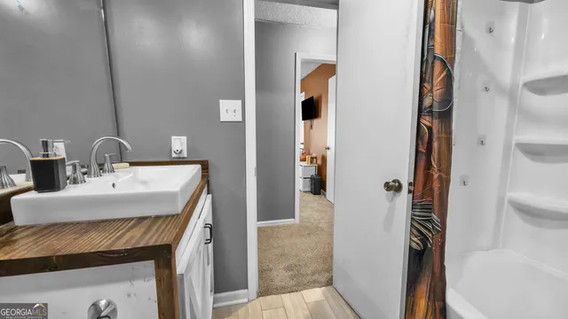 a bathroom with a sink and mirror