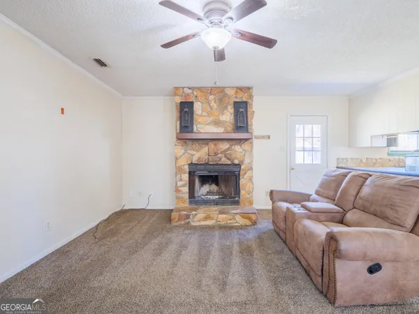 a kitchen with kitchen island granite countertop a sink cabinets and a counter top space