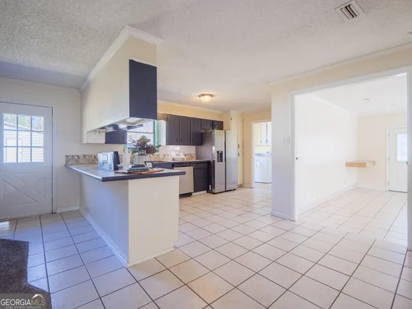 a living room with a furniture and a flat screen tv