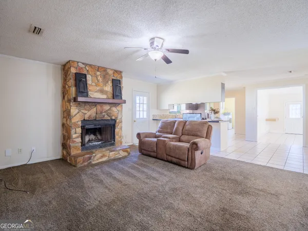 a room with a baby bed furniture and a window