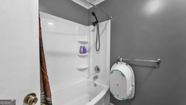 a bathroom with a toilet a sink and shower