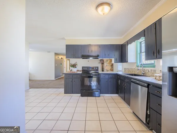 a kitchen with stainless steel appliances wooden cabinets and a sink