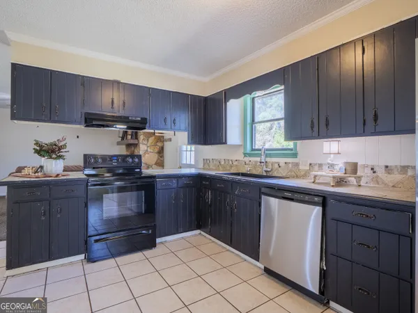 an empty room with closet and a chandelier fan