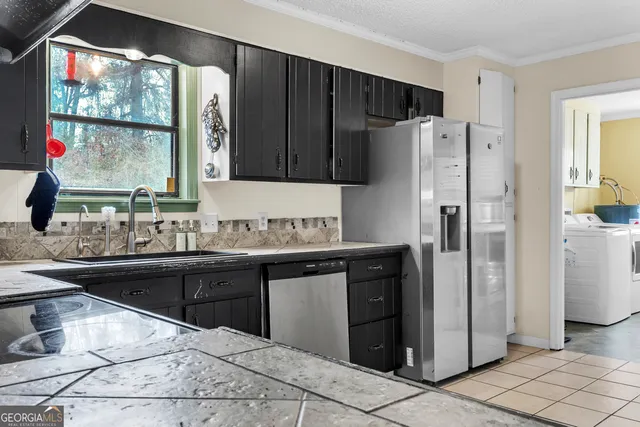 a kitchen with kitchen island a counter top space cabinets and stainless steel appliances
