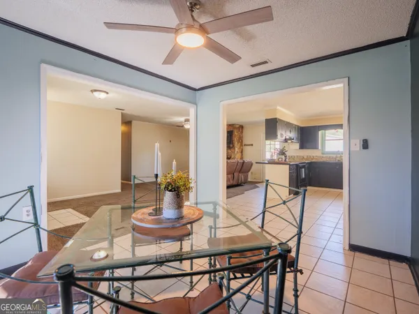 a kitchen with kitchen island a counter top space cabinets and stainless steel appliances