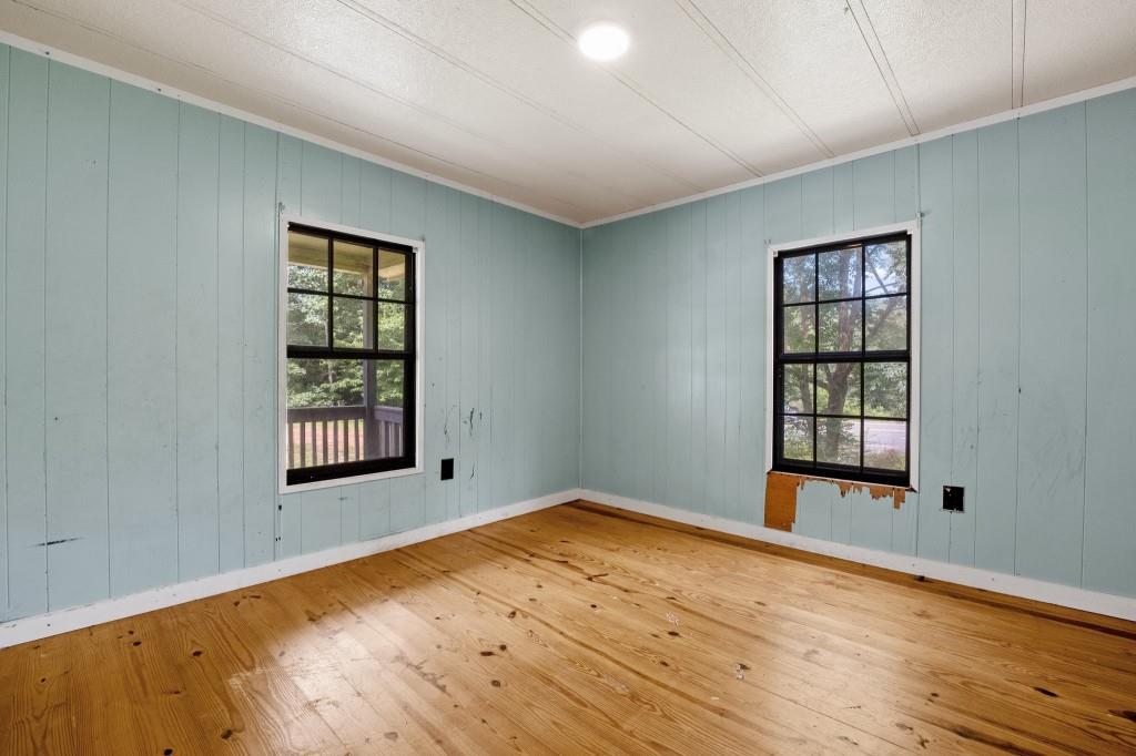 9503 Tails Creek Road Ellijay, GA 30540 - Photo 18 of 30 an empty room with wooden floor and windows