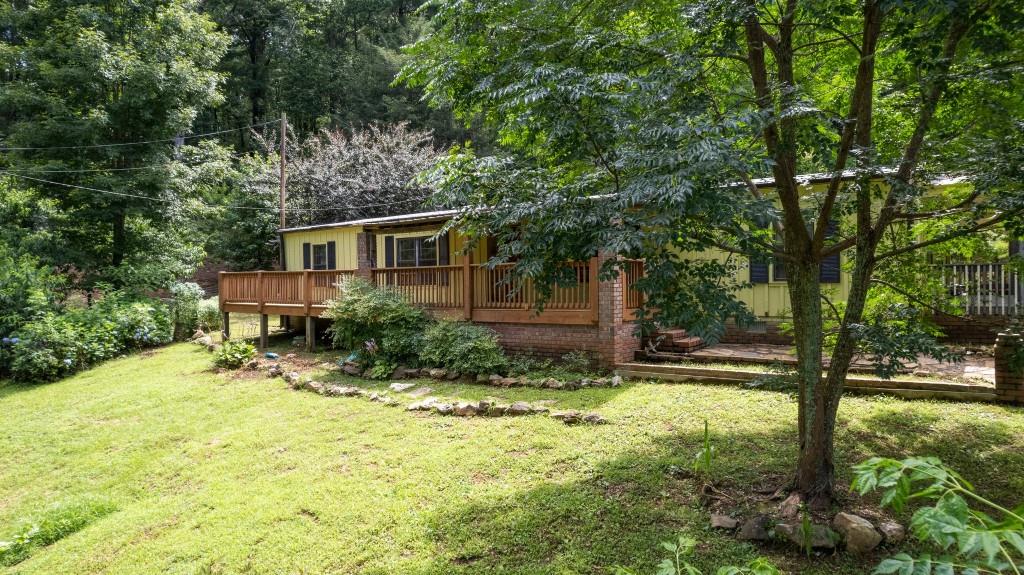 9503 Tails Creek Road Ellijay, GA 30540 - Photo 2 of 30 a house with trees in front of it