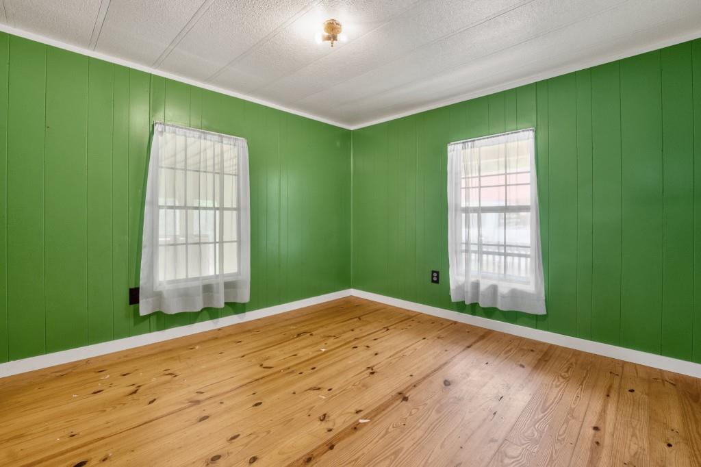 9503 Tails Creek Road Ellijay, GA 30540 - Photo 21 of 30 a view of an empty room with a window and wooden floor