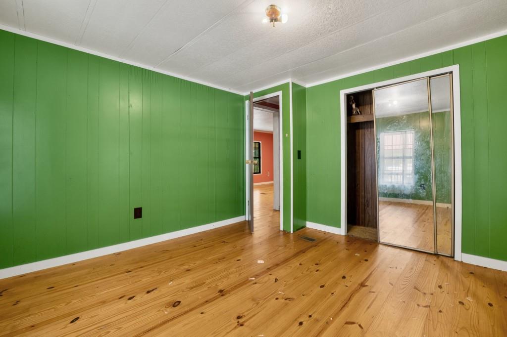 9503 Tails Creek Road Ellijay, GA 30540 - Photo 22 of 30 a view of an empty room with window and wooden floor