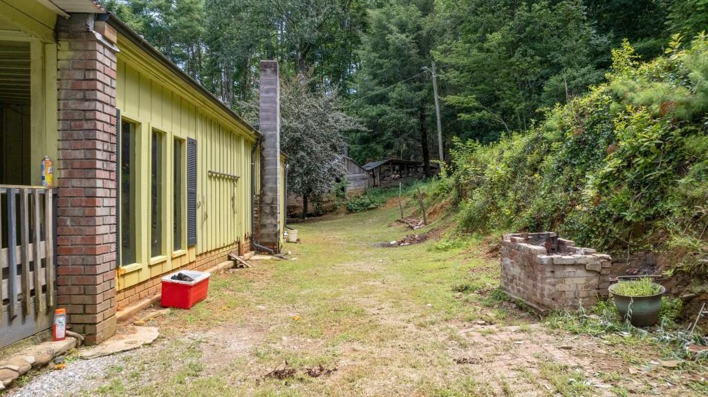 9503 Tails Creek Road Ellijay, GA 30540 - Photo 24 of 30 a backyard of a house with outdoor seating