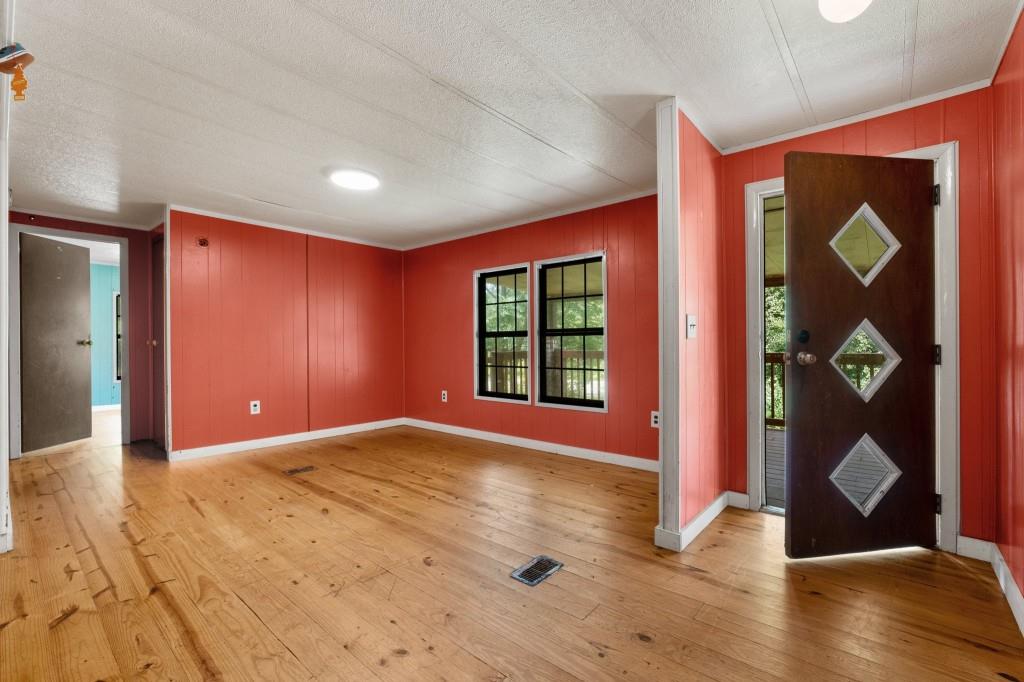 9503 Tails Creek Road Ellijay, GA 30540 - Photo 5 of 30 a view of an empty room with wooden floor and a window