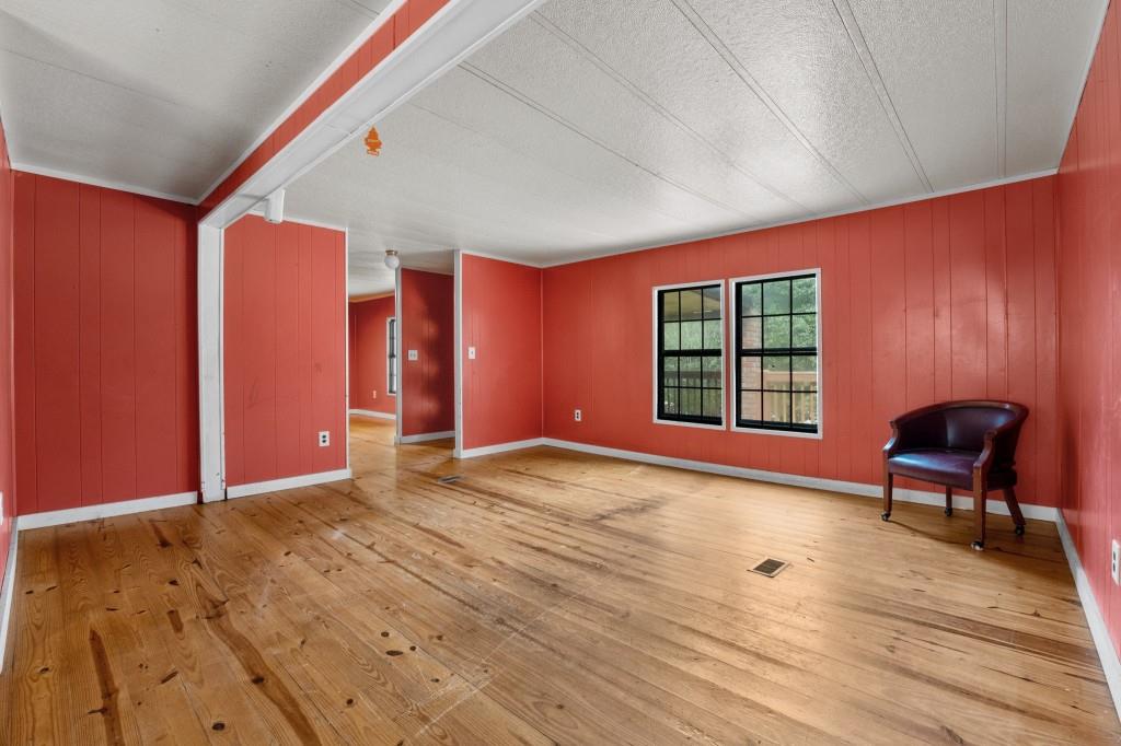 9503 Tails Creek Road Ellijay, GA 30540 - Photo 7 of 30 a view of an empty room with a window and wooden floor
