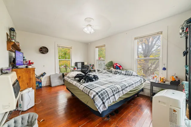 a bed sitting in a bedroom next to a window