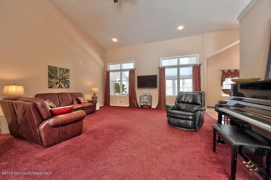33 Larrison Road Wrightstown, NJ 08562 - Photo 13 of 35 a living room with furniture a flat screen tv and a window