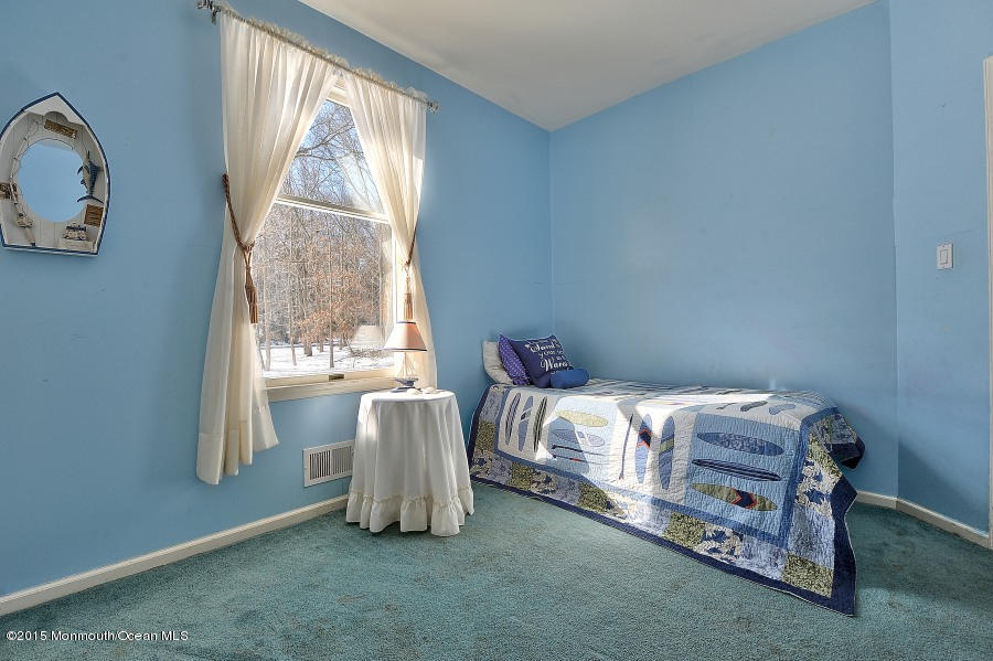 33 Larrison Road Wrightstown, NJ 08562 - Photo 25 of 35 a bed sitting in a bedroom next to a window