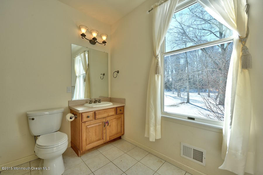 33 Larrison Road Wrightstown, NJ 08562 - Photo 27 of 35 a bathroom with a toilet sink and mirror