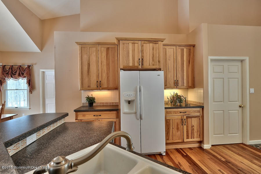 33 Larrison Road Wrightstown, NJ 08562 - Photo 5 of 35 a kitchen with a refrigerator and a stove top oven