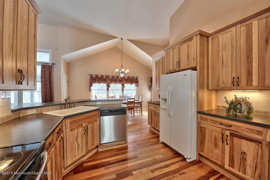 33 Larrison Road Wrightstown, NJ 08562 - Photo 6 of 35 a kitchen with stainless steel appliances granite countertop a refrigerator a sink dishwasher a stove and white countertops with wooden floor
