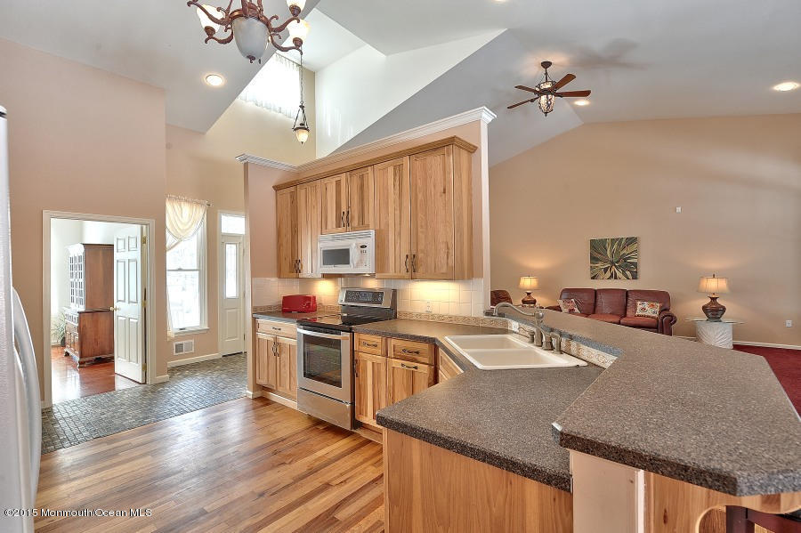 33 Larrison Road Wrightstown, NJ 08562 - Photo 7 of 35 a kitchen with stainless steel appliances granite countertop a sink stove and refrigerator