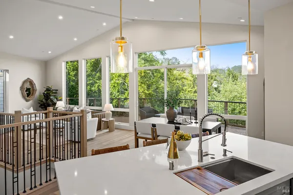 a kitchen with stainless steel appliances kitchen island granite countertop a sink a stove and a microwave