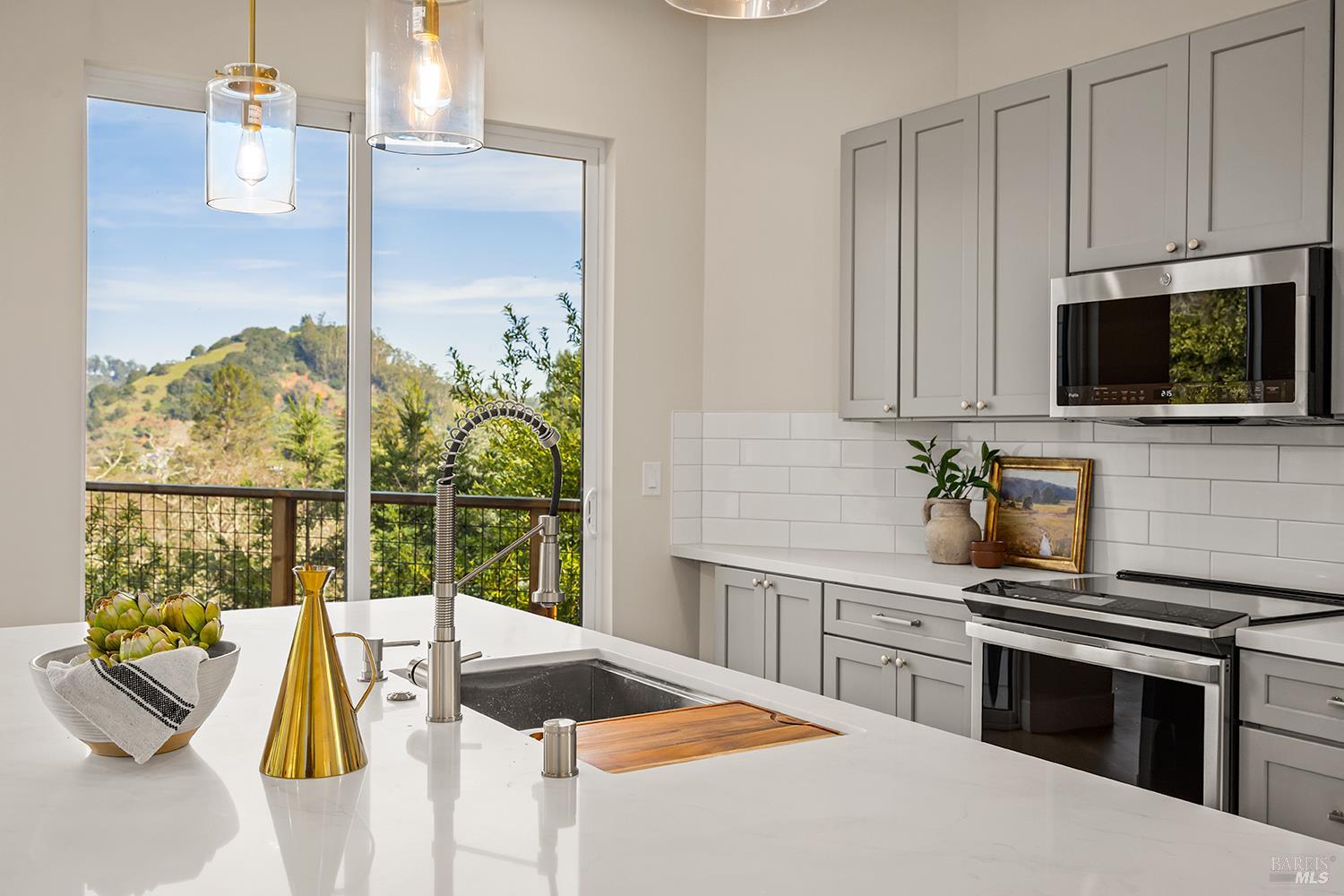 745 Redwood Road San Anselmo, CA 94960 - Photo 16 of 47 a kitchen with stainless steel appliances kitchen island granite countertop a sink a stove and a microwave