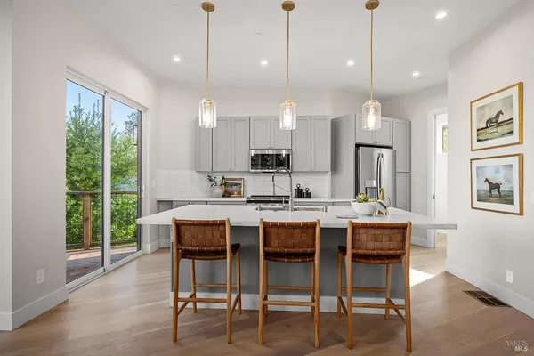 a living room with furniture and kitchen view