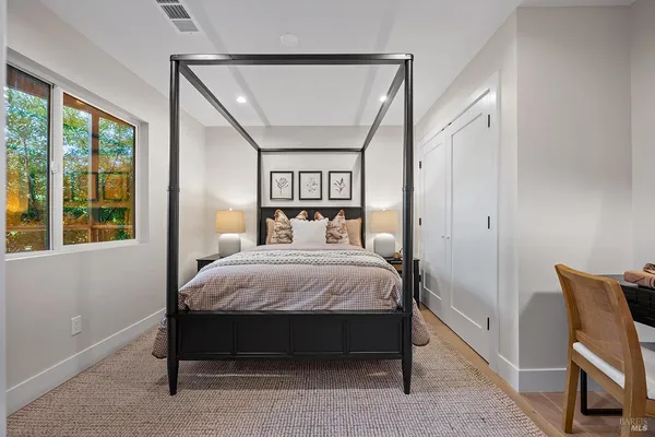 a bedroom with a bed and a mirror