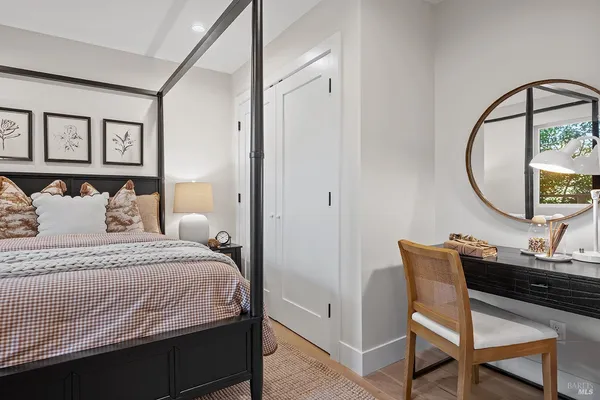 a bathroom with a granite countertop sink mirror vanity and toilet