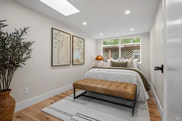 a bedroom with a bed and a night stand