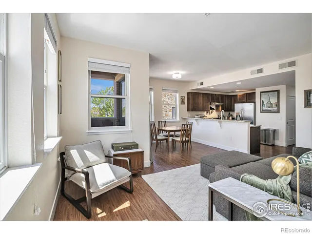 a living room with furniture and view of kitchen