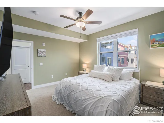 a bedroom with a large bed and a chandelier