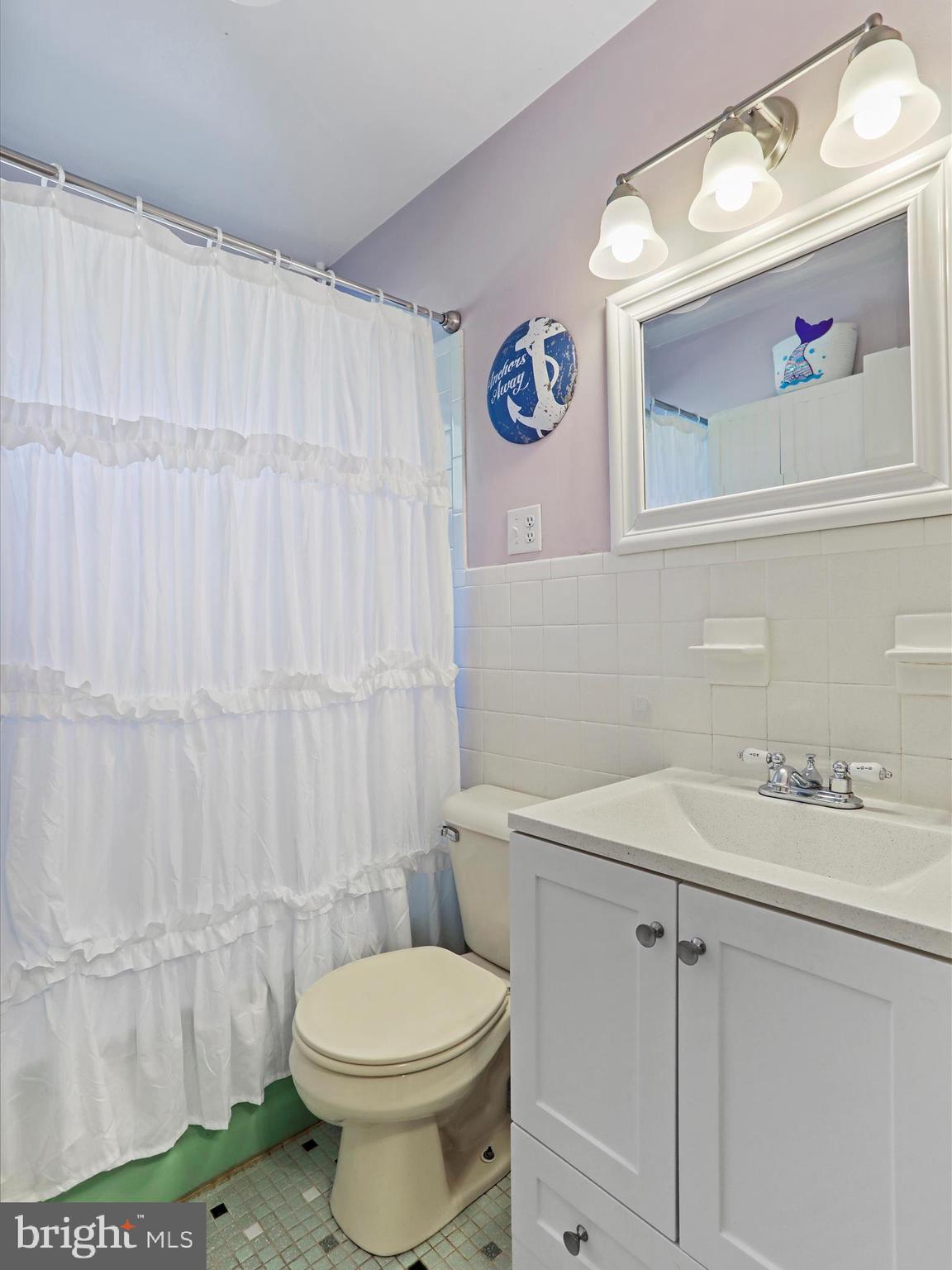 12530 Ashton Road Clear Spring, MD 21722 - Photo 22 of 57 a bathroom with a sink a toilet and shower curtain