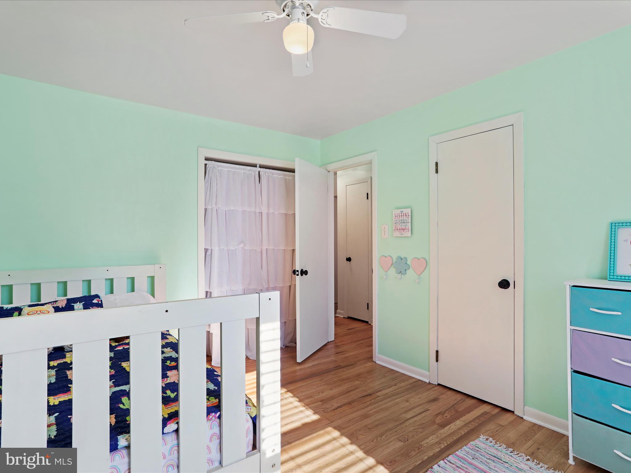 12530 Ashton Road Clear Spring, MD 21722 - Photo 26 of 57 a view of a bedroom with baby crib and wooden floor